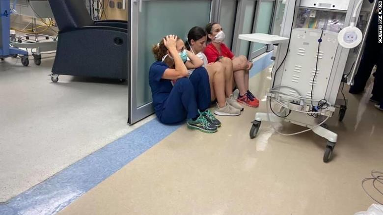 nurses huddling in corridor